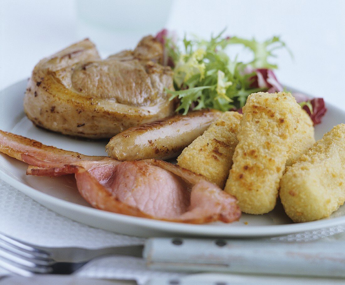 Bacon, sausage and steak with potato croquettes and salad