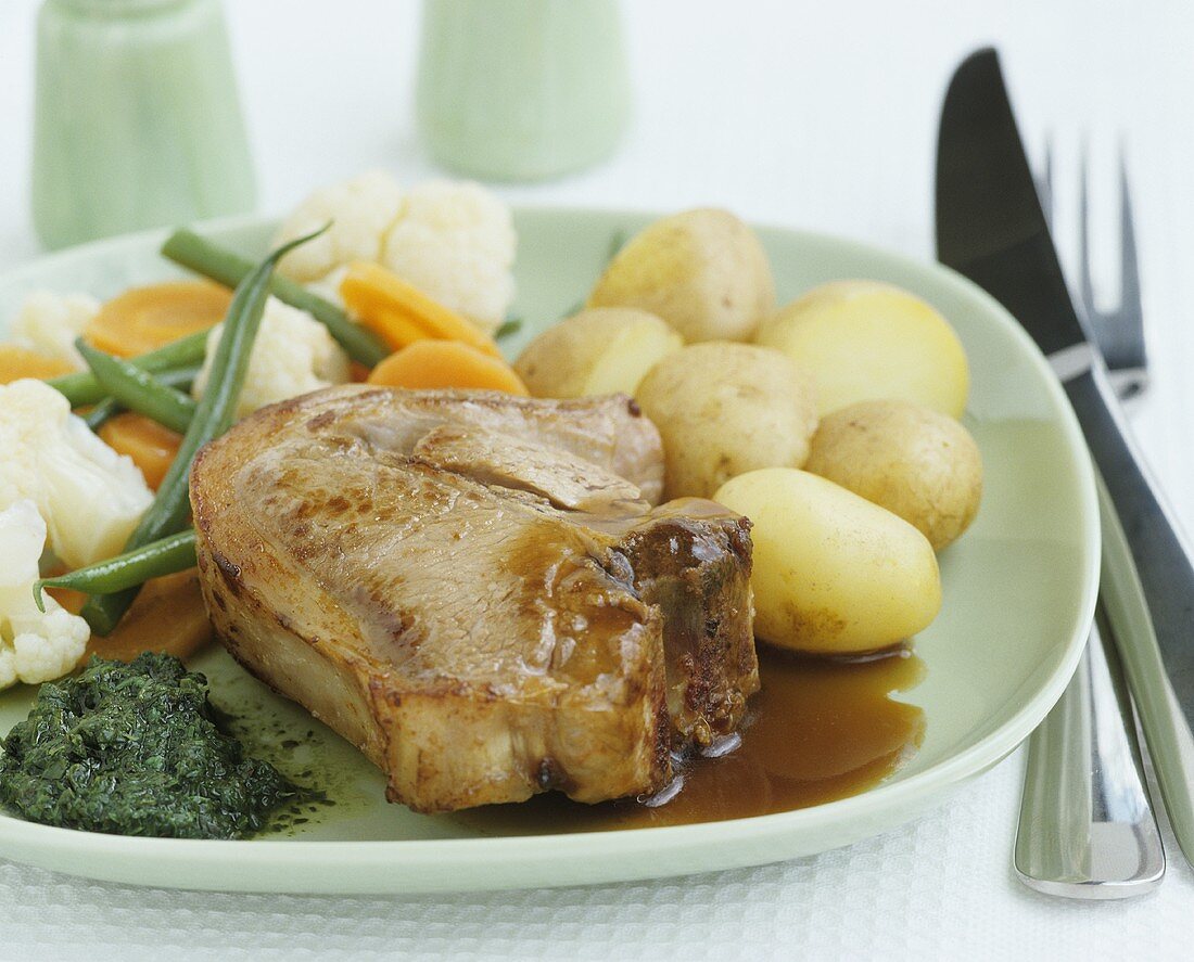 Pork chop with gravy and vegetables