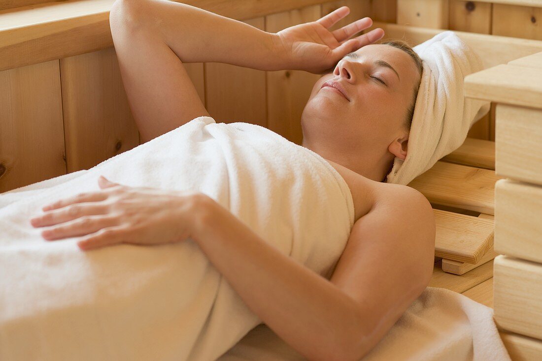 Woman lying in a sauna