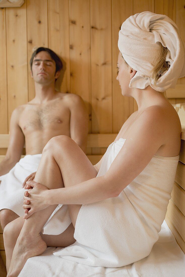 Man and woman sitting in a sauna