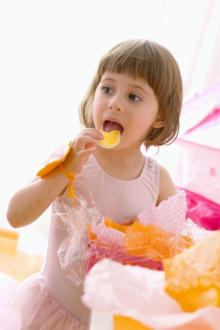 Kleines Mädchen isst Süssigkeiten