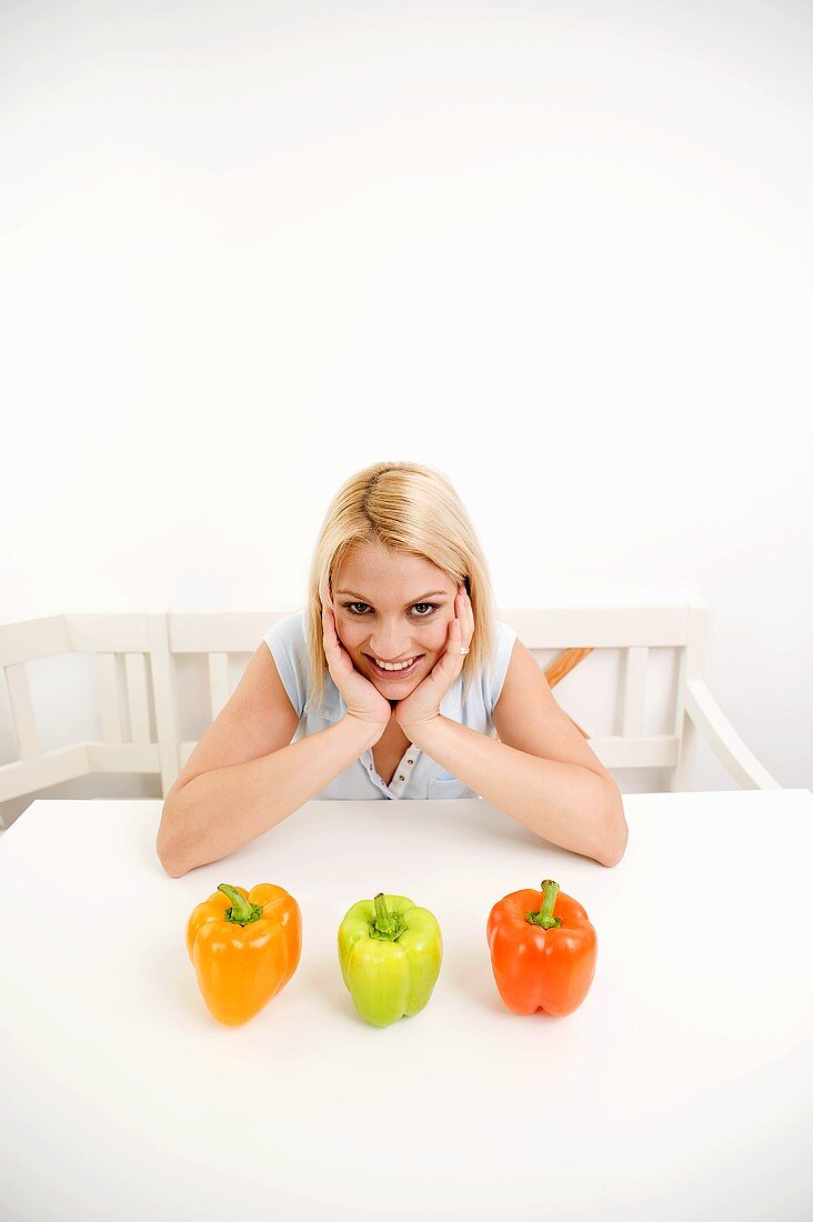 Young woman with three peppers