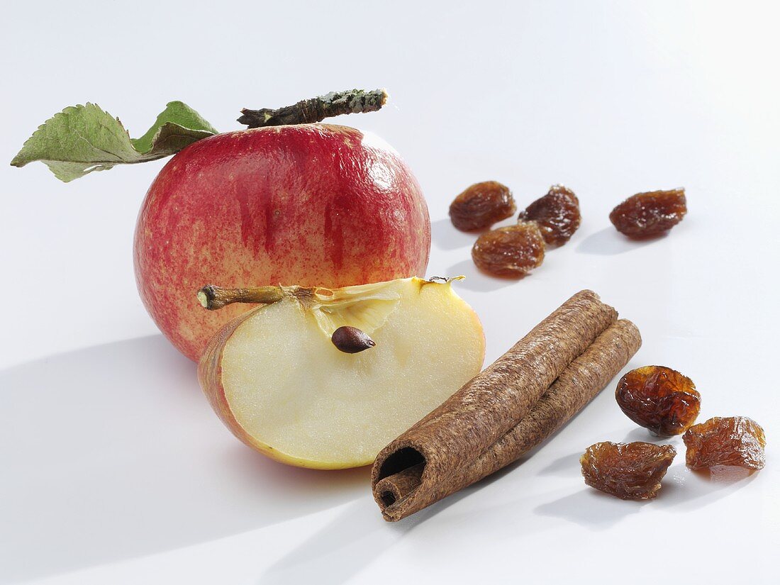 Apple with cinnamon stick and raisins
