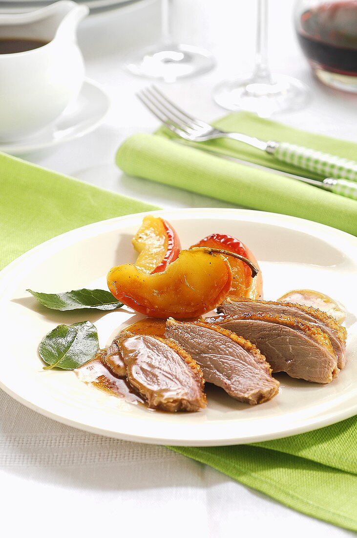 Roast goose breast with peach wedges