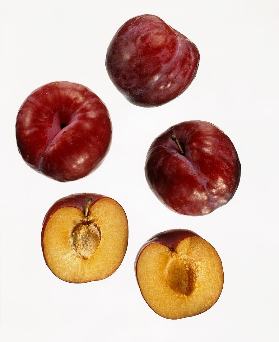 Red plums, whole and halved