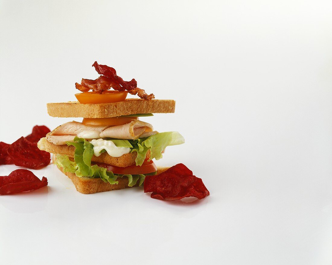 A club sandwich and beetroot chips
