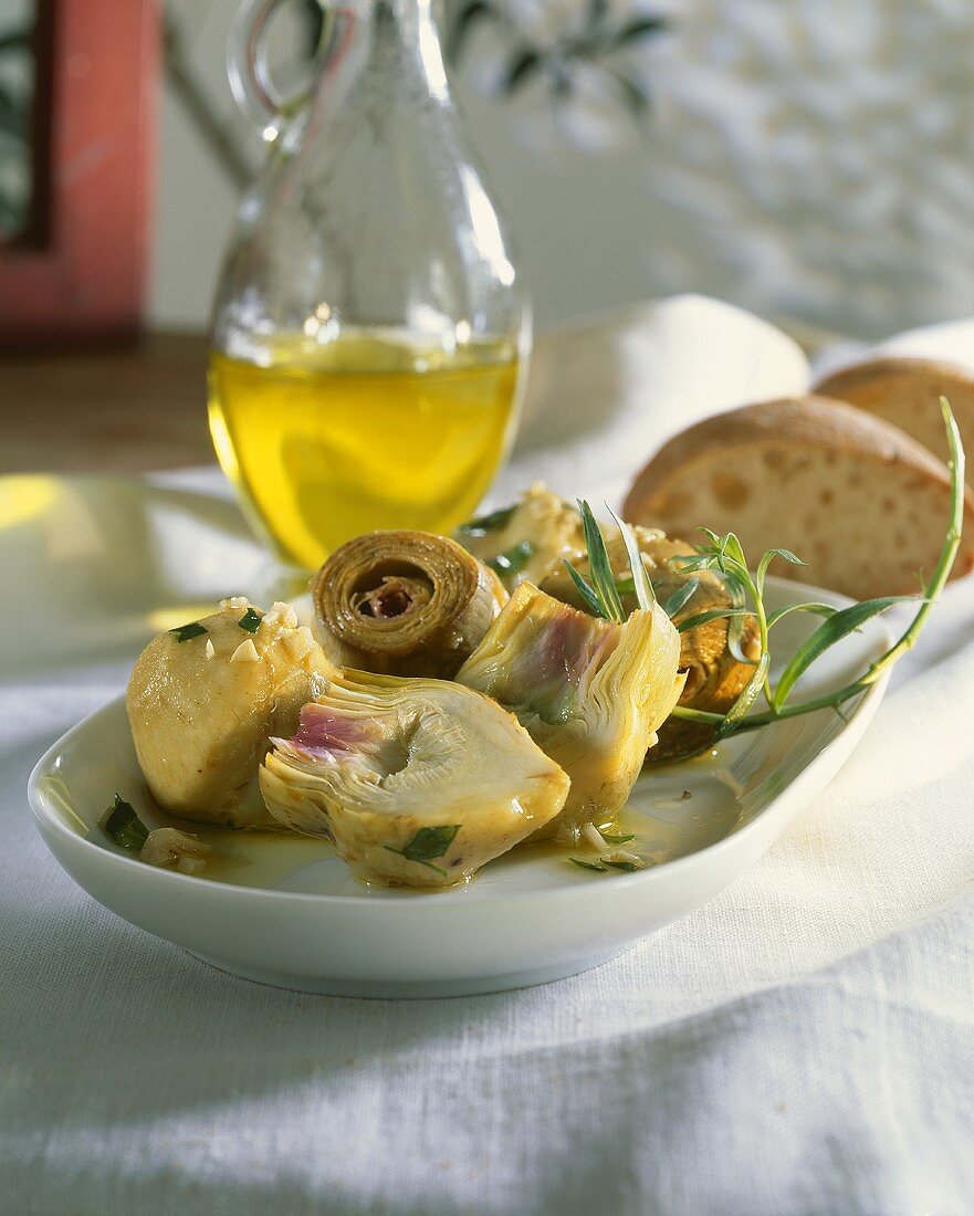 Steamed Artichokes on Plate with Herbed Olive Oil
