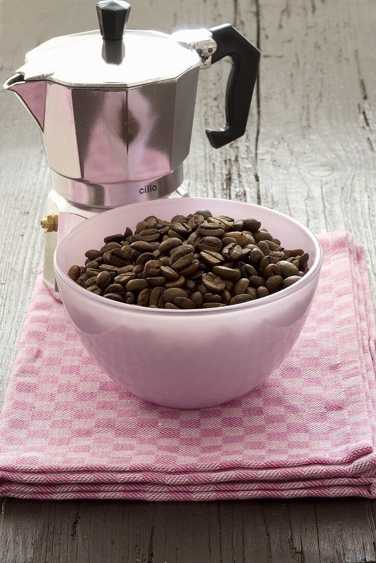 Espresso pot with a small bowl of espresso beans