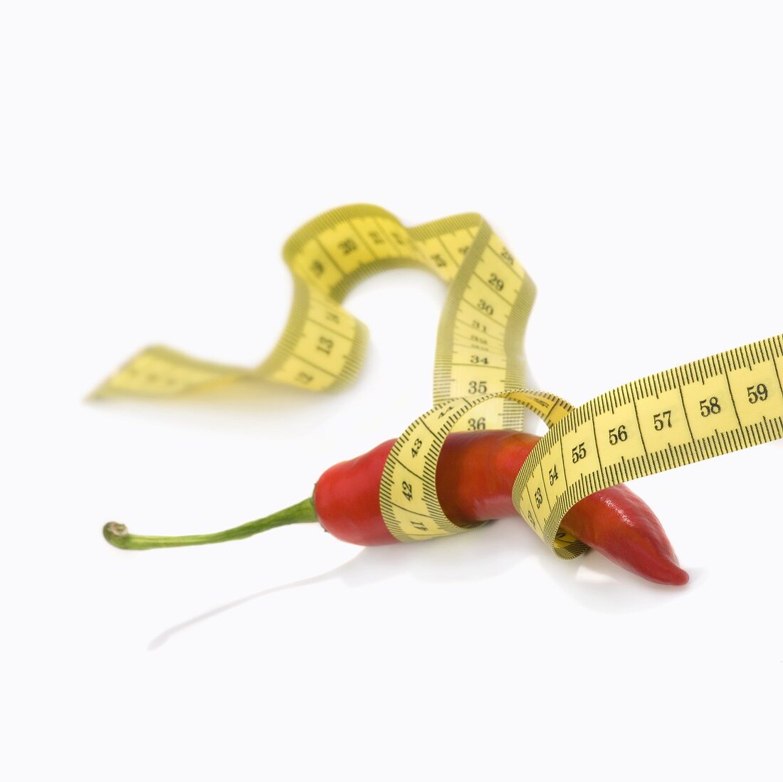 A chilli with a tape measure around it