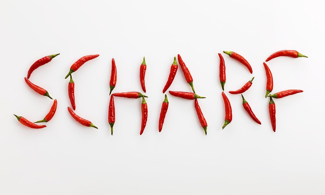 The word 'SCHARF' ('Spicy' in German) written in red chillies