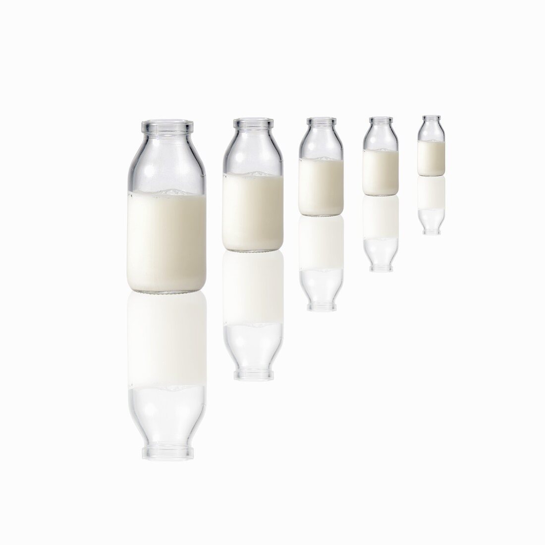Five milk bottles on a reflecting surface