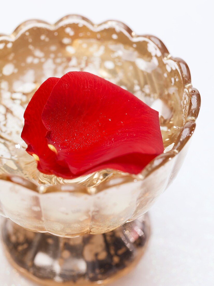 Red rose petals in silver dish