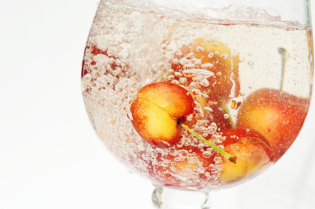Sweet cherries in a glass of water