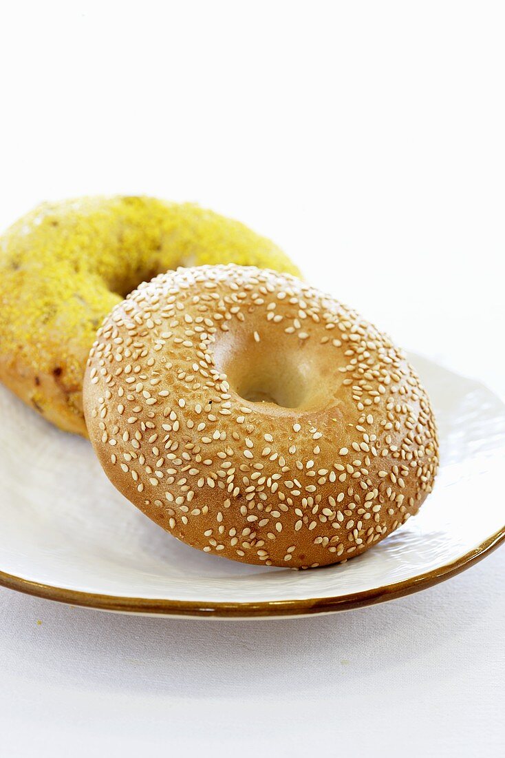 A sesame bagel and a cheese bagel