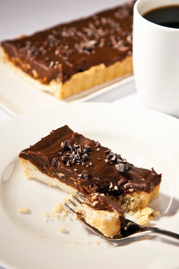 Piece of Chocolate Hazelnut Tart with Shortbread Crust; Fork; Espresso