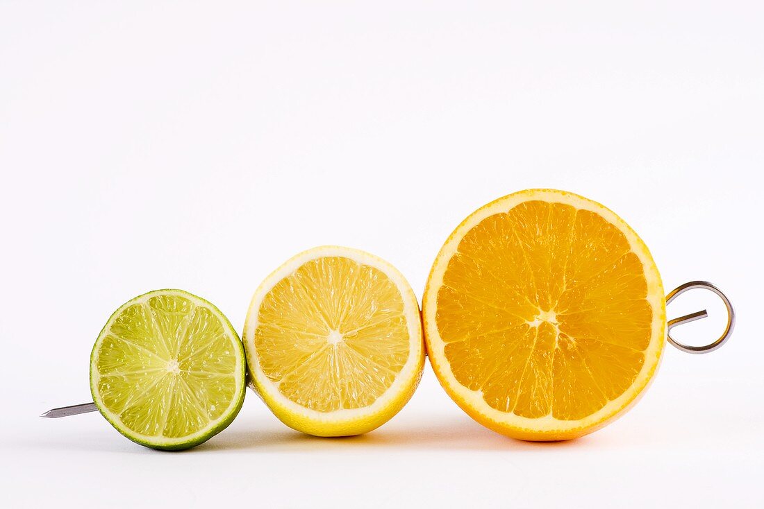 Half a lime, half a lemon and half an orange on a skewer