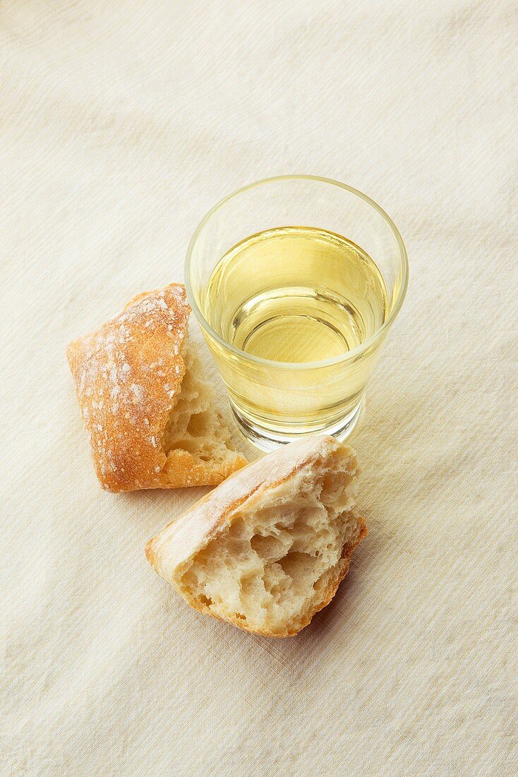 Glass of White Wine with Crusty Roll