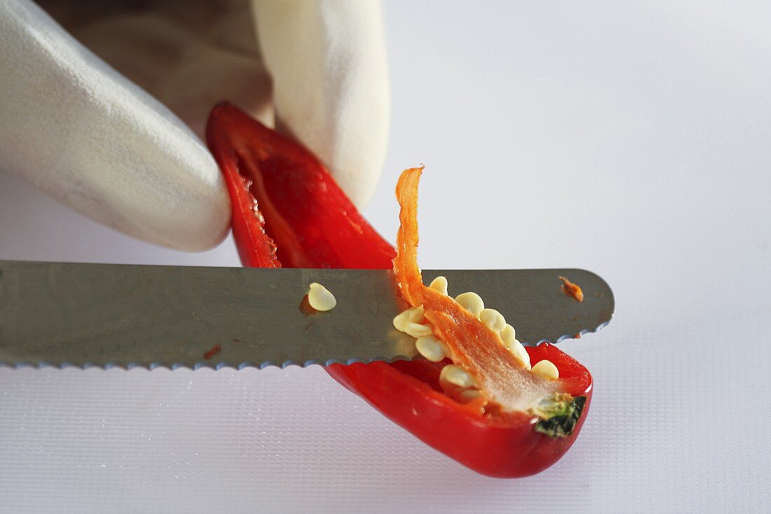 A chilli pepper being deseeded