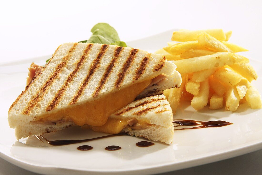 Toasted cheese and ham sandwich with chips