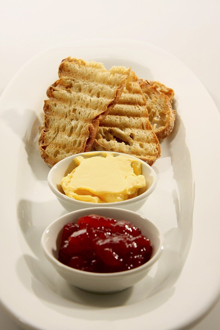 Strawberry jam, butter and toasted ciabatta