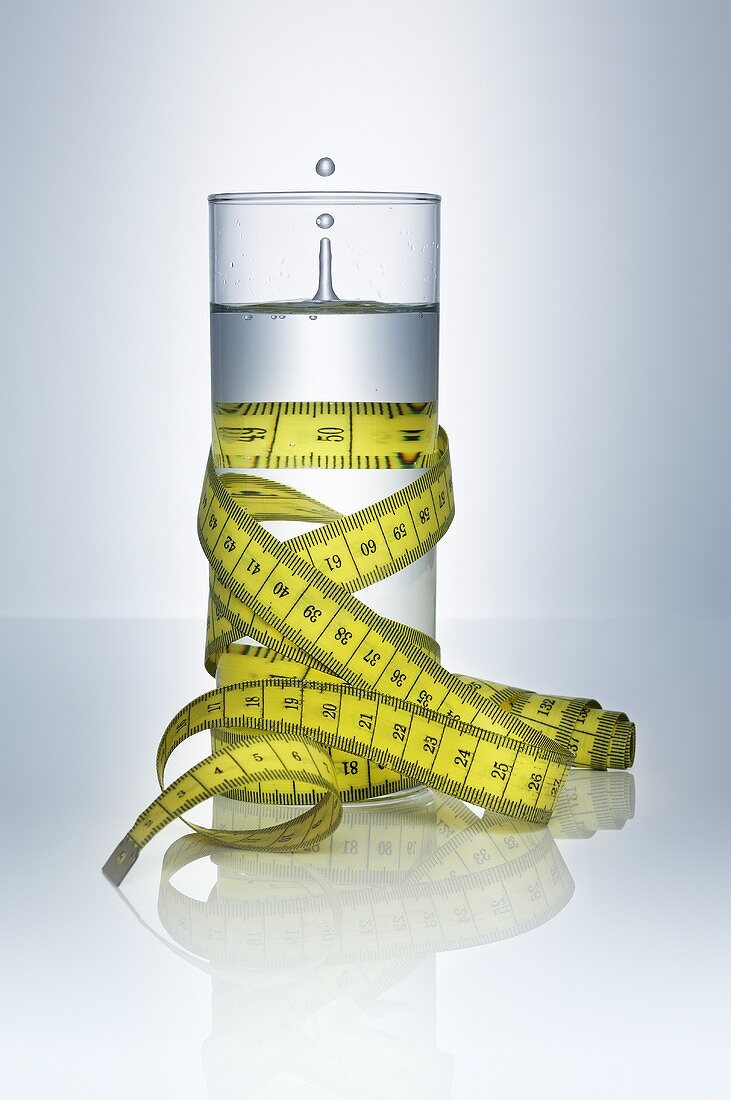 A glass of water with a tape measure