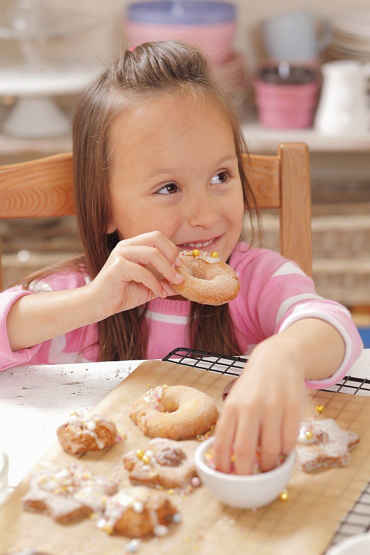 A girl eating freshly baked Christmas biscuits