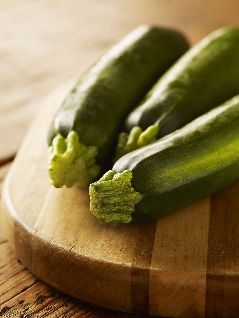 Three Whole Zucchini on a Cutting Board