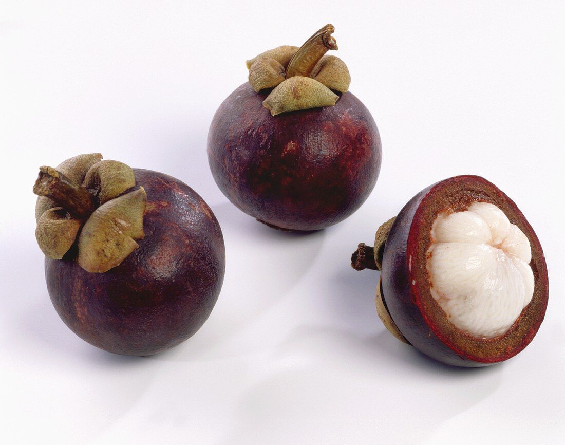 Two whole and one half mangosteen