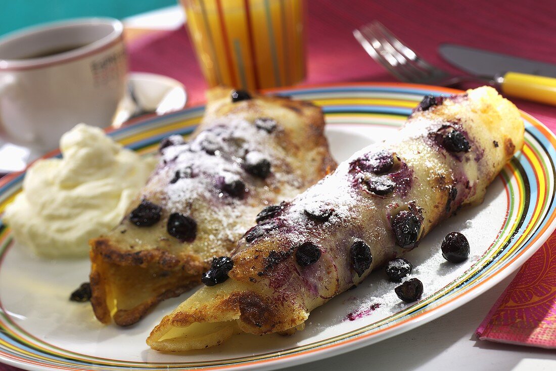 Two blueberry pancakes with cream