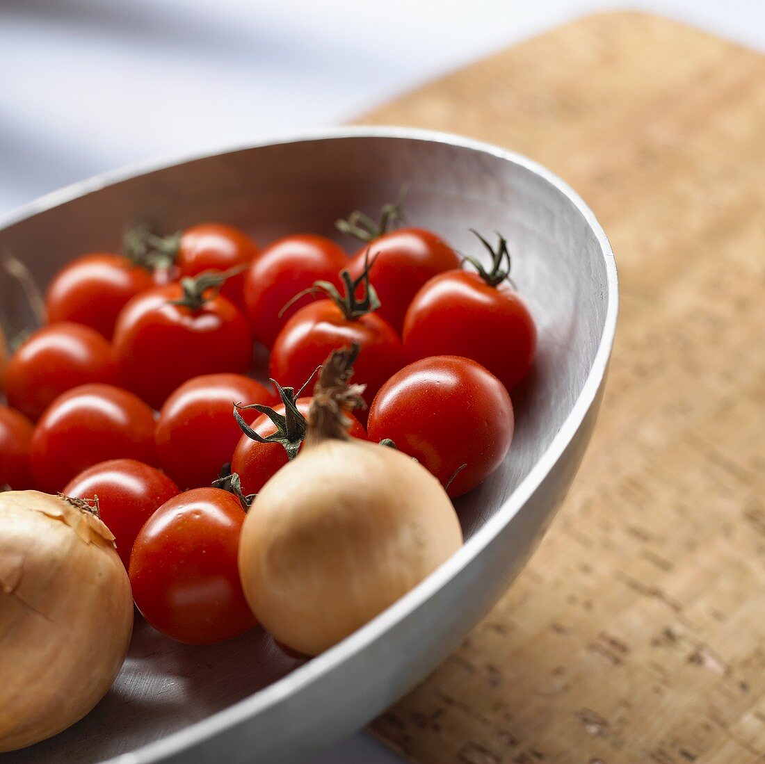 Cocktail tomatoes and onions in a bowl