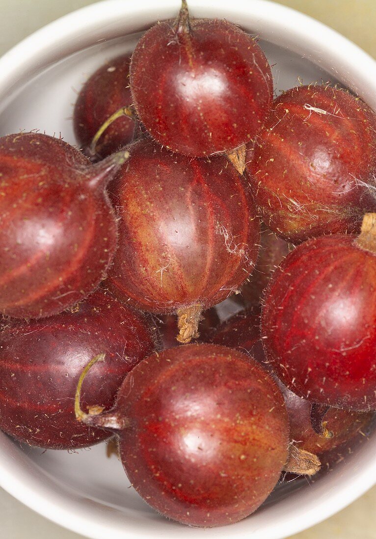 Red gooseberries in a small bowl