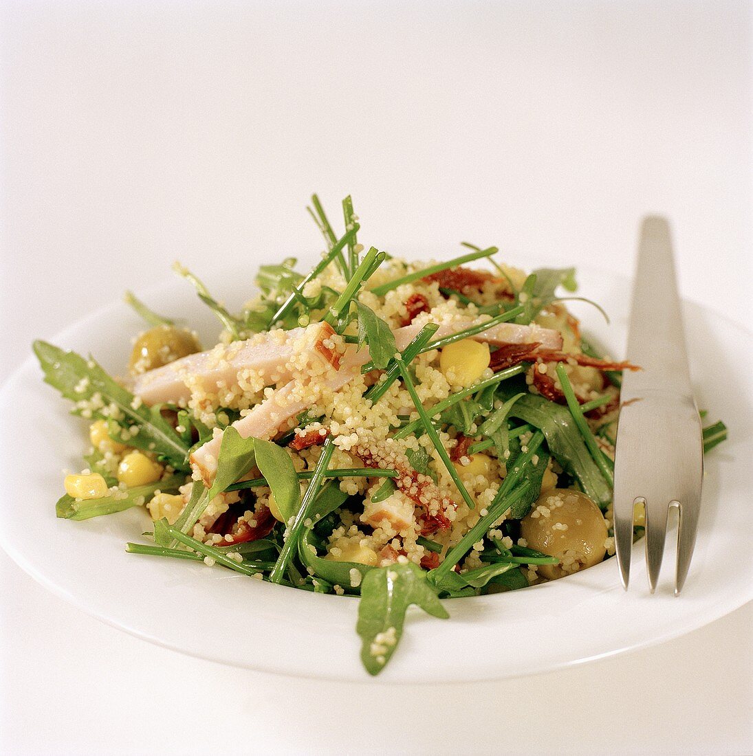 Rocket and couscous salad with strips of turkey