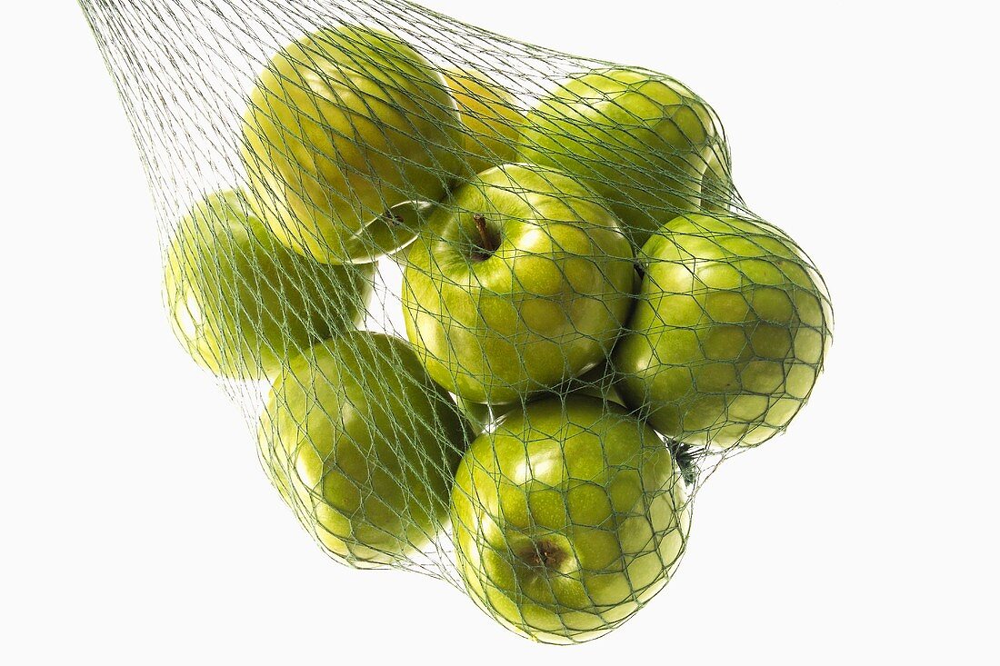 Granny Smith Äpfel in grünem Einkaufsnetz