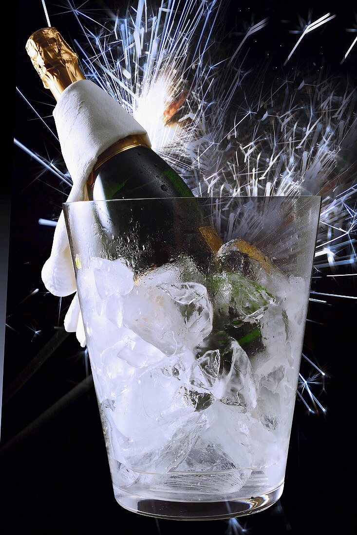 Sparkling wine still life: cooler, bottle & shower of sparks