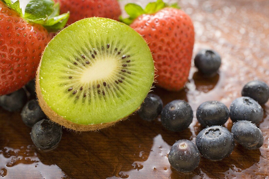 Half a kiwi fruit, blueberries and strawberries