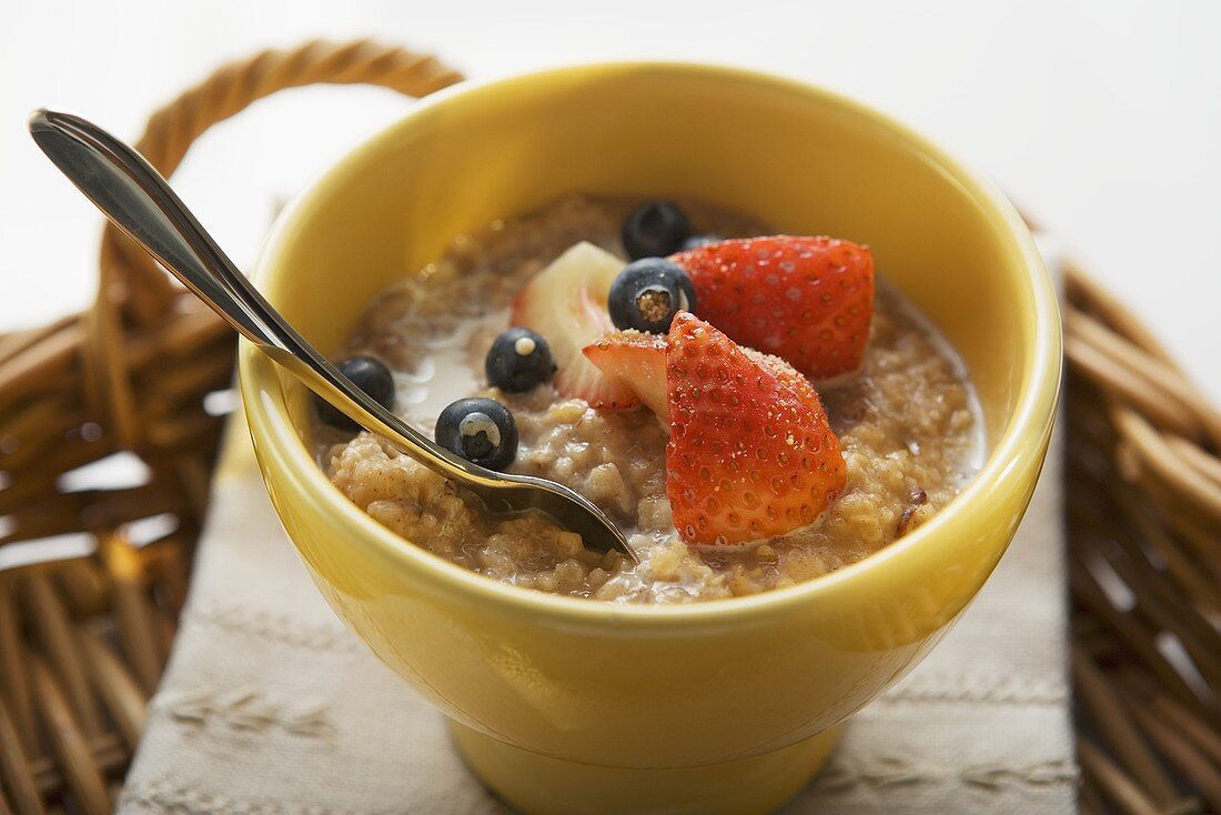 Porridge with milk and berries on tray