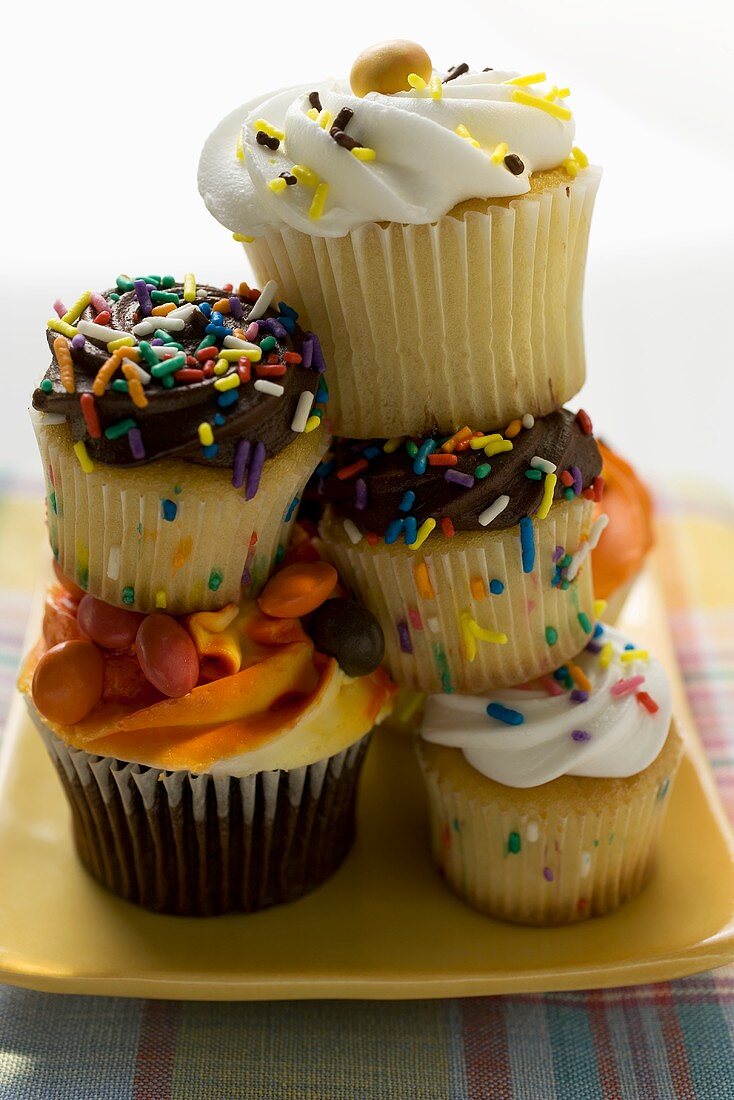 A pile of colourful decorated muffins