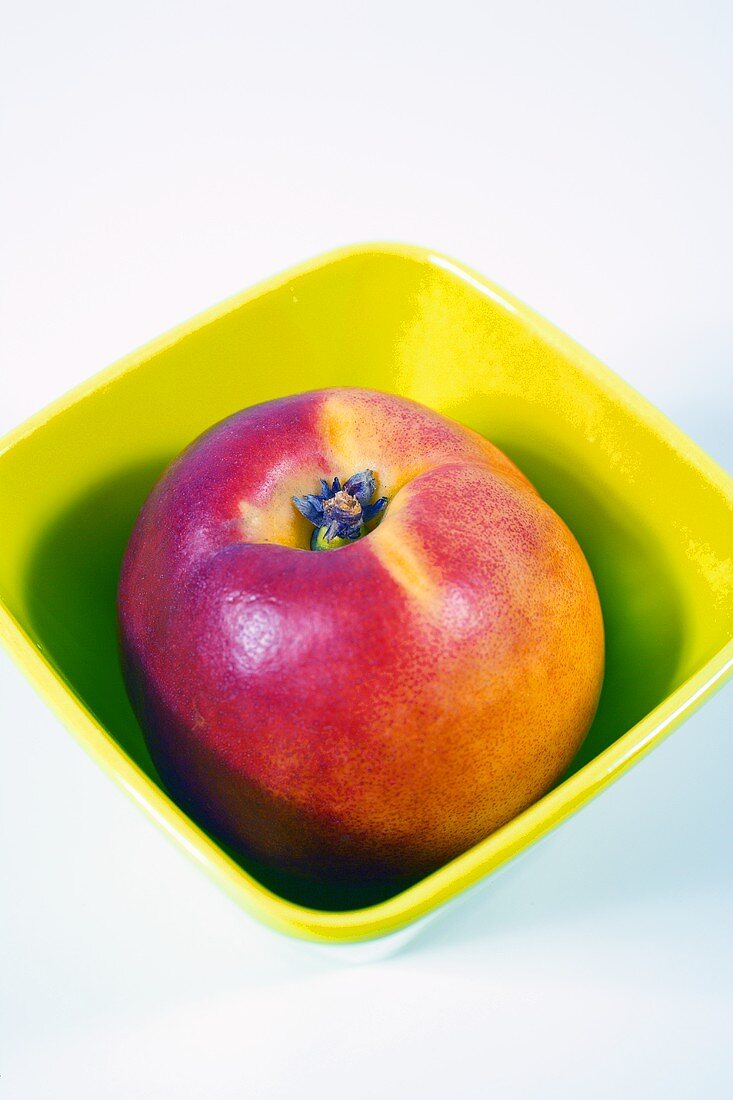 Peach in plastic bowl