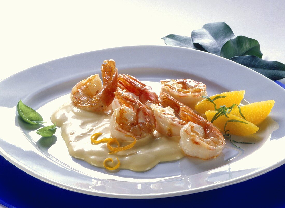 Shrimps in cocktail sauce with orange wedges