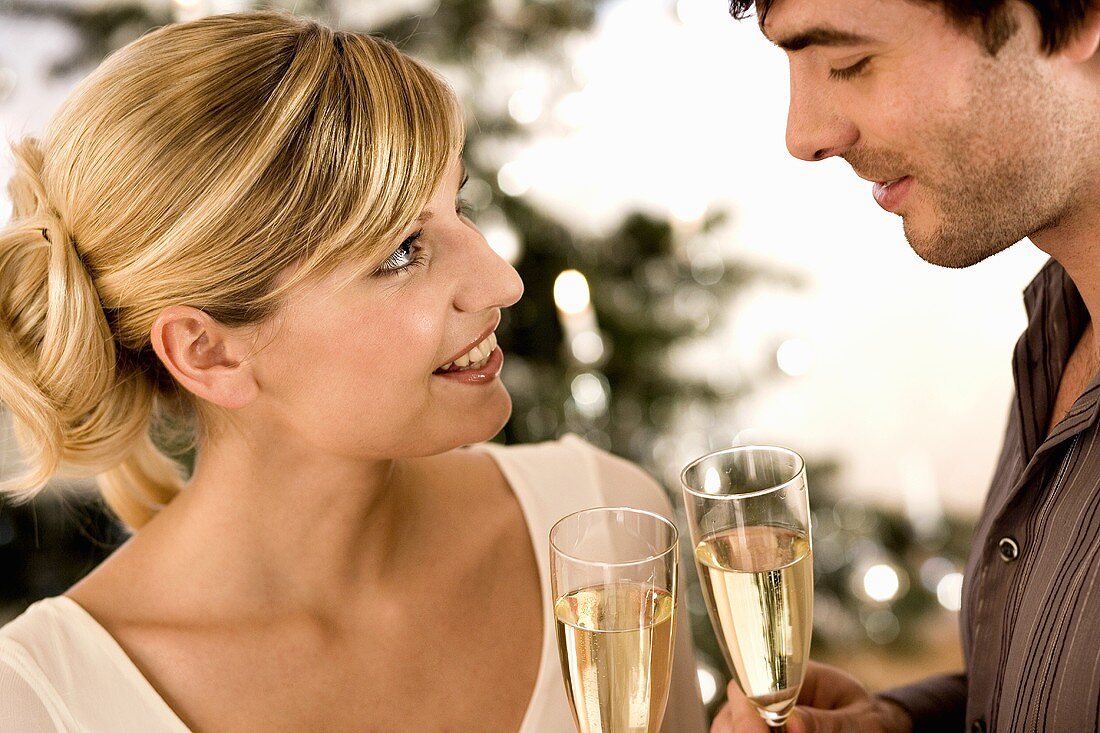 Man and woman clinking champagne glasses