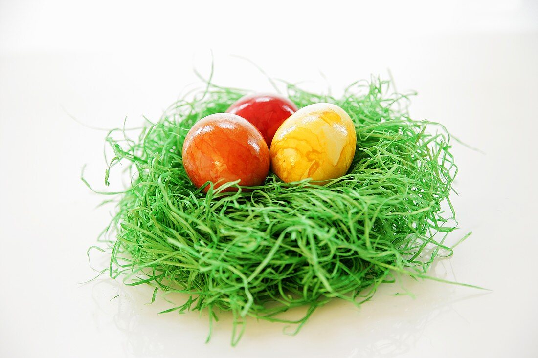 Osternest mit drei gefärbten Eiern