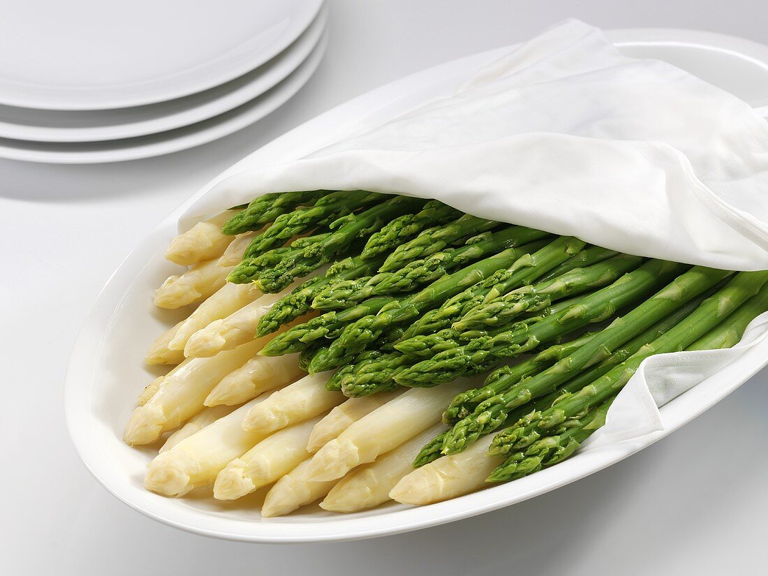 Cooked white and green asparagus on a platter