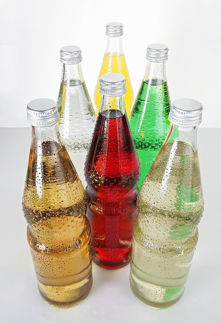 Six bottles of different fizzy drinks