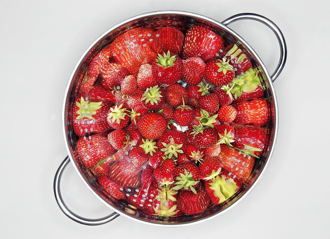 Fresh strawberries in a colander