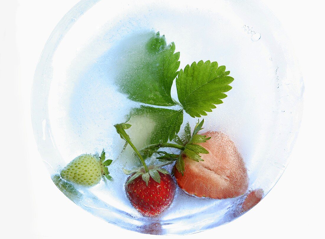 Strawberries with leaves in ice