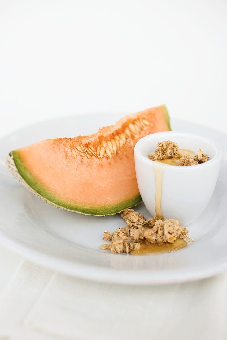 Yoghurt with muesli, honey and melon