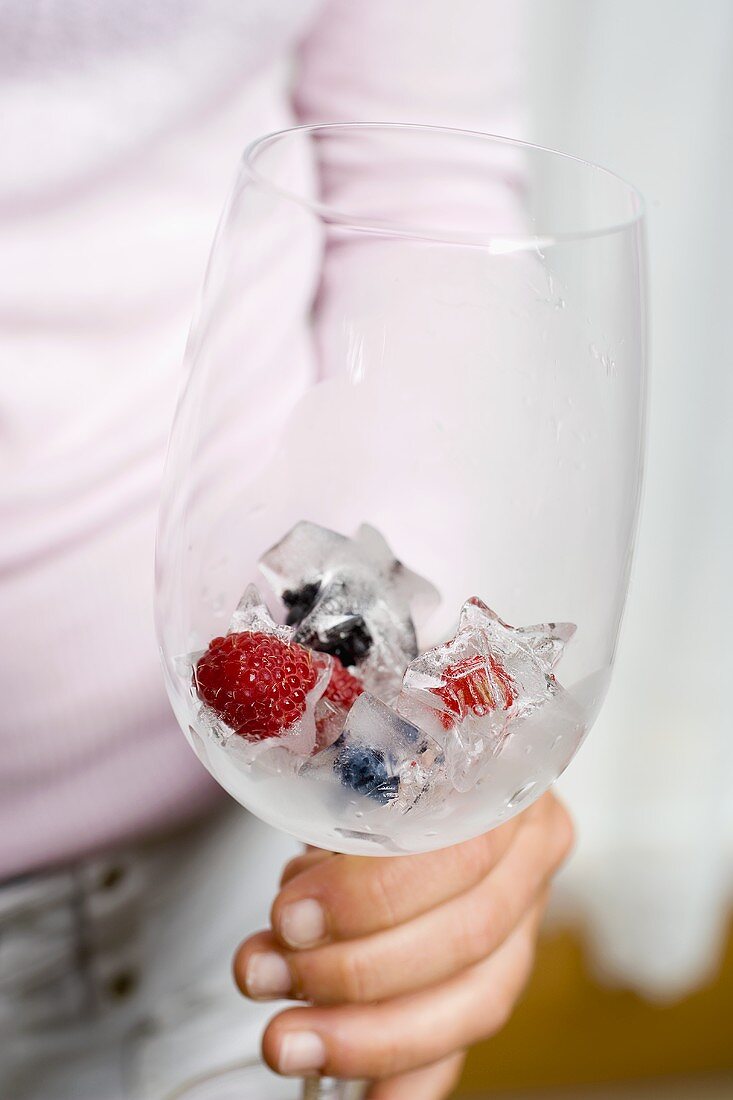 Berry ice cubes in glass