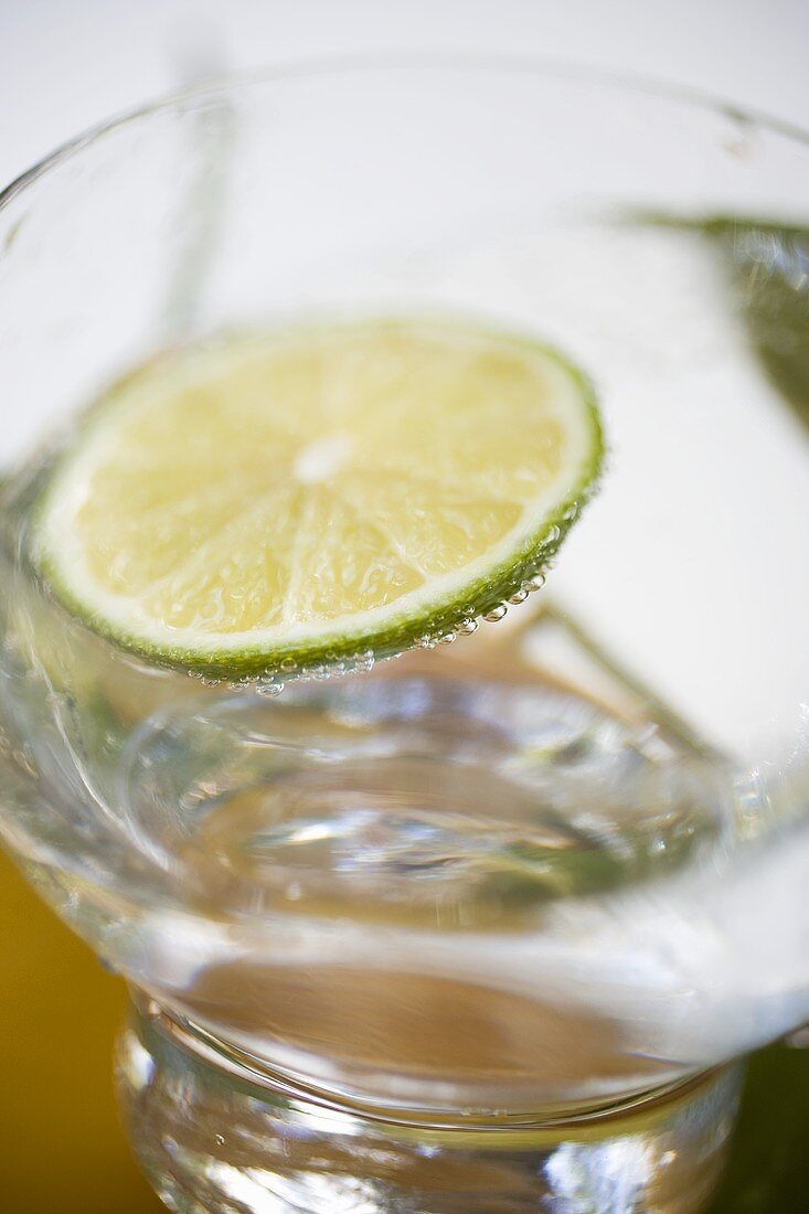 A glass of mineral water with slice of lime