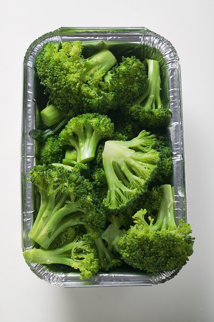 Steamed broccoli in an aluminium container