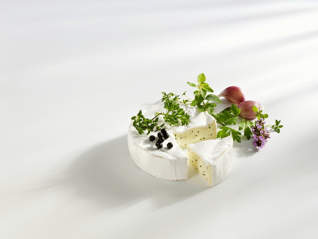 Camembert with herbs, a wedge cut